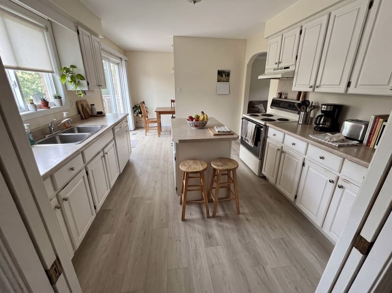 After: the same kitchen with Greige Oak vinyl plank, rendered by the Flooring Local visualizer